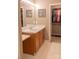 Well-lit bathroom with a single sink vanity, framed mirror, and a walk-in closet at 103 Pine Meadows Cir, Hickory, NC 28601