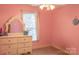 Bright pink bedroom with a large dresser and mirror, creating a cheerful atmosphere at 103 Pine Meadows Cir, Hickory, NC 28601