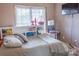 Cozy bedroom with built-in headboard shelving and a calming, neutral color palette at 103 Pine Meadows Cir, Hickory, NC 28601