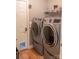 Well-equipped laundry room with modern washer and dryer units and a convenient pet door at 103 Pine Meadows Cir, Hickory, NC 28601