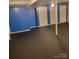 Finished area in the basement featuring a dark painted floor and accent wall at 1033 College Ave, Shelby, NC 28152