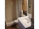 Close-up of a bathroom featuring wood accents, shower, toilet and sink with vanity at 1033 College Ave, Shelby, NC 28152