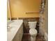 Inviting bathroom featuring a white vanity, toilet, and a shower-tub combination with a colorful curtain at 1033 College Ave, Shelby, NC 28152