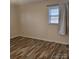 Simple bedroom with natural light and wood-look vinyl flooring at 1033 College Ave, Shelby, NC 28152