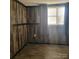 Cozy bedroom with wood paneling and window at 1033 College Ave, Shelby, NC 28152