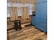 Bright kitchen area featuring blue cabinets, modern flooring, and natural light from the window at 1033 College Ave, Shelby, NC 28152