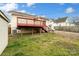 Backyard with a wooden deck, green grass, and a view of neighboring houses at 1111 W 4Th Ave, Gastonia, NC 28052