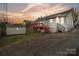 Charming home with a red wood deck and shed in the backyard, perfect for outdoor entertaining at 1111 W 4Th Ave, Gastonia, NC 28052