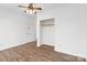 Bedroom with a ceiling fan, wood-look floors, white walls, and a closet with sliding doors at 1111 W 4Th Ave, Gastonia, NC 28052