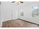 Bedroom with white walls, wood-look floors, and natural light from the surrounding windows at 1111 W 4Th Ave, Gastonia, NC 28052