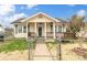 Charming home featuring a covered front porch with columns and a fenced yard under a sunny sky at 1111 W 4Th Ave, Gastonia, NC 28052