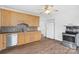 Kitchen featuring wooden cabinets, stainless steel appliances, and wood-look flooring at 1111 W 4Th Ave, Gastonia, NC 28052