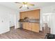 Kitchen featuring wooden cabinets, a stainless steel sink, and wood-look floors with an open doorway at 1111 W 4Th Ave, Gastonia, NC 28052