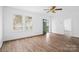 Sunlit living room featuring neutral walls, ceiling fan, and hardwood floors at 1111 W 4Th Ave, Gastonia, NC 28052