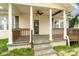 Inviting covered front porch with decorative columns and ceiling fan at 1111 W 4Th Ave, Gastonia, NC 28052