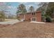 Brick home showcasing an expansive backyard with a detached garage and patio area at 1114 University Dr, Lancaster, SC 29720