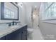 This bathroom features a sink with granite countertops and a glass enclosed shower at 1114 University Dr, Lancaster, SC 29720