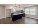 Bright, open kitchen featuring blue cabinets, quartz countertops, and stainless steel appliances at 1114 University Dr, Lancaster, SC 29720