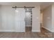 Walk in pantry with a sliding barn door and open shelves at 1114 University Dr, Lancaster, SC 29720