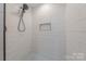 A stunning shower features white tile and accent shower floor tiling at 1114 University Dr, Lancaster, SC 29720