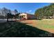 Expansive backyard features a covered patio and mature trees, perfect for outdoor entertaining and relaxation at 1168 Mcclain Rd, Hiddenite, NC 28636