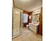 Functional bathroom featuring a shower stall, a classic vanity, and neutral tile flooring at 1168 Mcclain Rd, Hiddenite, NC 28636