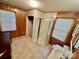 A compact bathroom featuring wood paneling, a shower stall, and a corner sink at 1168 Mcclain Rd, Hiddenite, NC 28636