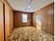 Bedroom with wood paneling, patterned carpet, a window and a ceiling fan at 1168 Mcclain Rd, Hiddenite, NC 28636