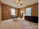 A cozy bedroom with wood paneled walls and ceiling fan at 1168 Mcclain Rd, Hiddenite, NC 28636