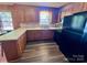 Traditional kitchen with oak cabinets, black appliances, and light countertops at 1168 Mcclain Rd, Hiddenite, NC 28636