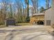 A backyard featuring a two-car garage and a wooden deck, both adding practical and aesthetic elements at 1200 Carey Ct, Charlotte, NC 28210