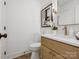 Bathroom with a vanity with a sink, a tiled floor, a toilet and new fixtures at 1200 Carey Ct, Charlotte, NC 28210