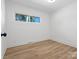 A bright, modern bedroom featuring hardwood floors and ample natural light from a well-placed window at 1200 Carey Ct, Charlotte, NC 28210