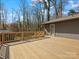 Spacious wood deck great for entertaining, overlooking a scenic wooded yard and charming gray house at 1200 Carey Ct, Charlotte, NC 28210