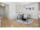 Cozy dining area with modern table setting, light fixture, and natural light streaming through the windows at 1200 Carey Ct, Charlotte, NC 28210