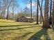 Lawn view of the home, complemented by trees, showcasing the house's position at 1200 Carey Ct, Charlotte, NC 28210