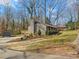 Exterior side view featuring a spacious yard, shed and a charming brick home at 1200 Carey Ct, Charlotte, NC 28210