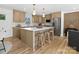 This modern kitchen features an island with seating, stainless steel appliances and hardwood floors at 1200 Carey Ct, Charlotte, NC 28210