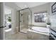 Bright bathroom with a soaking tub, seamless glass shower, and tile surround at 124 Helton Ln, Fort Mill, SC 29708