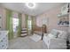 This neutral Bedroom offers bright light from two windows and plush carpeting at 124 Helton Ln, Fort Mill, SC 29708