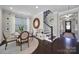 Open dining room area near staircase with round table and dark hardwood floors at 124 Helton Ln, Fort Mill, SC 29708