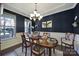 Formal dining room with a chandelier, wainscoting, and large windows at 124 Helton Ln, Fort Mill, SC 29708