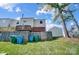 A view of this unit's back yard, including a raised back deck and a partial wood fence at 130 Water Oak Dr, Pineville, NC 28134