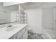 Bright bathroom features patterned tile floor, white vanity, and a shower-tub combo at 130 Water Oak Dr, Pineville, NC 28134