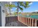 A lovely view of the lake is visible from this unit's wood deck with a wood railing and a large shade tree at 130 Water Oak Dr, Pineville, NC 28134