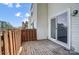 This back deck offers a sliding glass door, wood floor, and wood railing at 130 Water Oak Dr, Pineville, NC 28134