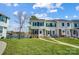 Charming townhome with green shutters and a well-manicured lawn leading to the front door near the lake at 130 Water Oak Dr, Pineville, NC 28134