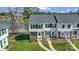 An elevated view of the townhome shows the green shutters, landscaping, and proximity to the lake at 130 Water Oak Dr, Pineville, NC 28134