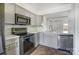 Modern kitchen with stainless appliances, tiled backsplash, and seamless access to the dining area at 130 Water Oak Dr, Pineville, NC 28134