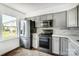 Updated kitchen with stainless steel refrigerator and bright window offering natural light, enhancing meal prep at 130 Water Oak Dr, Pineville, NC 28134